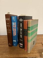 Spines of five technical books standing upright