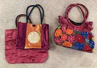 Overview of three purses laid flat
