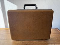 Front view of brown textured hardshell briefcase