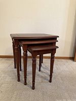 three stacked wooden nesting tables