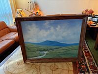 Front view of framed oil landscape painting