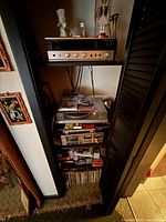 Shelf view showing Sansui receiver, Toshiba turntable, Sony cassette deck, records and tapes