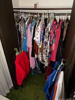 Closet view showing full lot of hanging vintage women’s garments