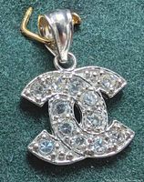 Front view of 10K CZ pendant on green background