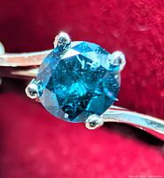 Close-up of blue diamond in four-prong 10K gold setting