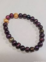 Full view of bracelet showing dyed freshwater pearls on elastic