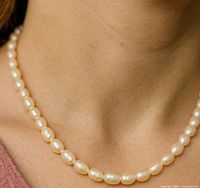 Necklace worn around neck showing length and pearl appearance