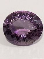 Front view of large faceted oval amethyst