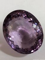 Front view of faceted oval amethyst showing checkerboard crown facets