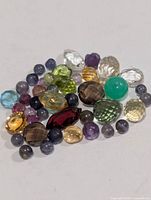 Group of assorted loose gemstones on white background