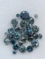 Close-up of assorted blue diamonds showing cuts and colour