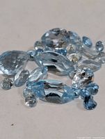Group of loose blue topaz stones showing various cuts