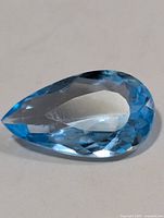 Top view of pear-shaped blue topaz gemstone
