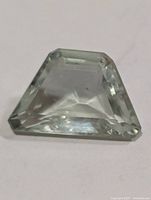 Top view of pale-green faceted gemstone