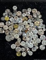 Close-up of loose round diamonds displaying colour mix and sizes