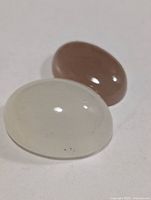 Close-up of translucent whitish and brown-peach moonstone cabochons