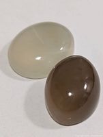 Off-white and brown oval cabochon moonstones