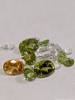 loose faceted gemstones on white background