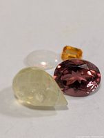 Four assorted loose gemstones displayed together