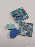 Four loose opal cabochons on neutral background