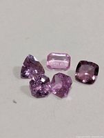 Five faceted pink sapphires close-up