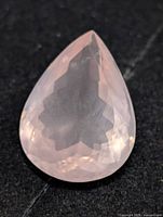 Front view of pear-shaped rose quartz showing faceted cut