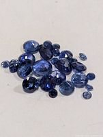 Loose faceted blue sapphires spread out for color and cut visibility