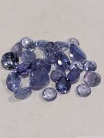 Loose violet-blue faceted tanzanite stones spread out