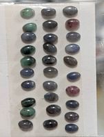 Front view of display card showing all 35 cabochon tourmalines