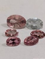 Six oval faceted tourmalines displayed on white background