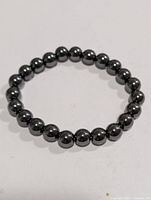 Full view of hematite bead bracelet in circular form