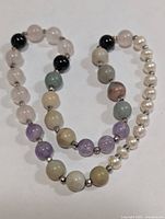 Full view of necklace showing variety of gemstone and pearl beads