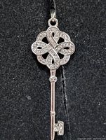 Front view of sterling silver CZ key pendant