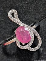 Front view of ring showing ruby CZ centre stone and clear CZ accents