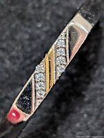 Close-up of ring top showing CZ stones and enamel accents