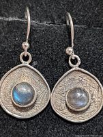 front view showing labradorite cabochons and textured silver discs