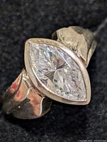 Top view of silver ring showing marquise-cut stone