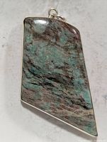 Front view of silver bezel trapezoid chrysocolla pendant with bail