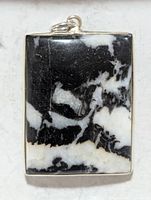 Front view of rectangular zebra jasper pendant in silver bezel