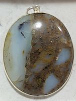 front view of oval moss agate pendant in silver