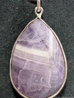 Front view of teardrop chevron amethyst pendant in silver bezel