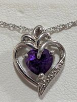 Close-up of heart pendant showing amethyst and accent stones