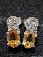 Front view of earrings showing citrine stones and diamond accents