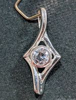 Front view of silver-tone pendant with round CZ stone