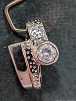 Front view of silver-tone pendant with bezel-set CZ