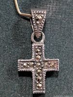 Front view of silver cross pendant with marcasite stones