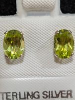 front view of peridot stud earrings on display card