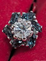 Top view showing clear central stone and surrounding dark blue marquise stones