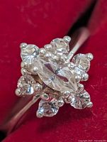 Top view of ring showing marquise center stone and surrounding round stones