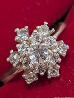 Front view of silver ring showing clear stone cluster